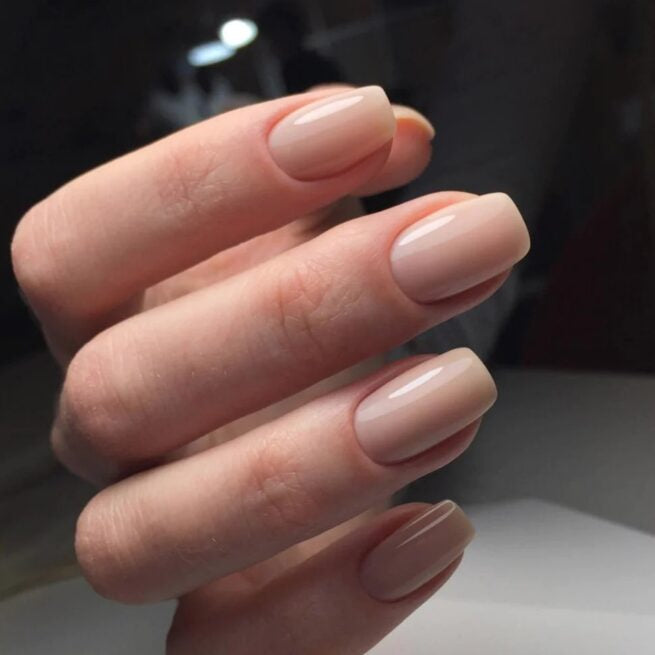 Close-up of natural manicure featuring sheer blush gel color.