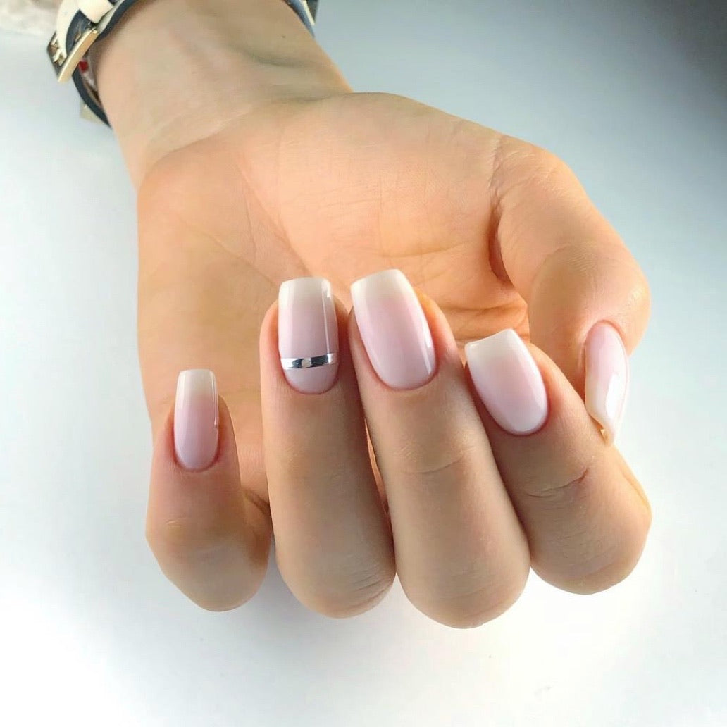 Studio shot of gel polish bottle next to a neat nail color swatch.