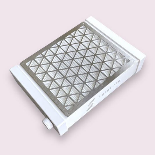 A compact white nail dust collector with a HEPA filter visible on the front, designed to be mounted on a wall or placed under a table.